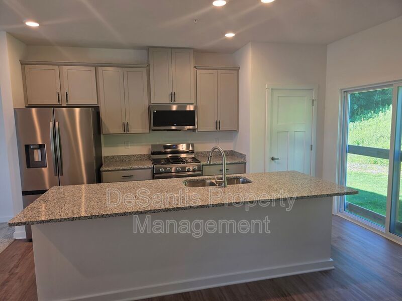 Brand-new townhome with modern finishes, flexible living space, and low-maintenance living. property image