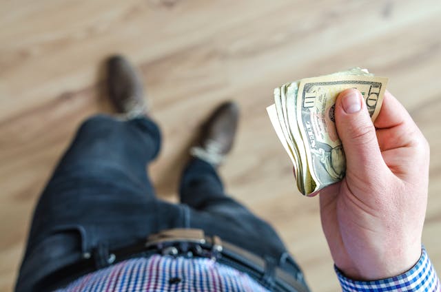 A landlord holding cash.