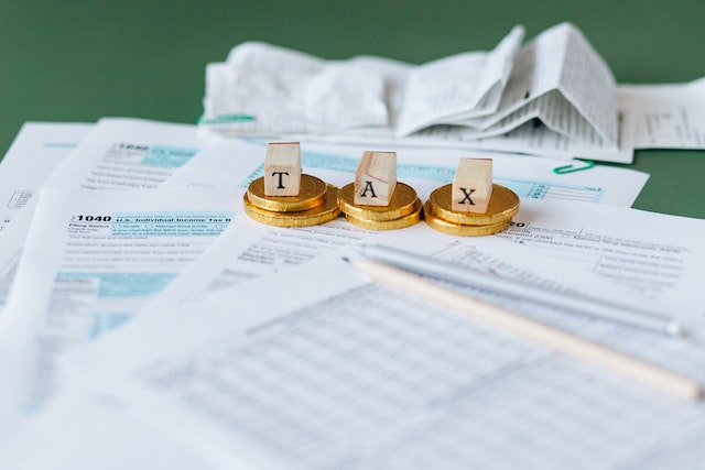 tax-documents-on-the-table-with-wooden-blocks-spelling-taxes